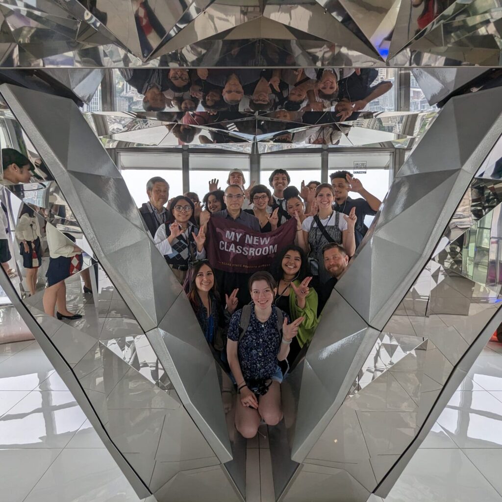 A group photo of the School of Journalism and Mass Communication in Tokyo Tower 