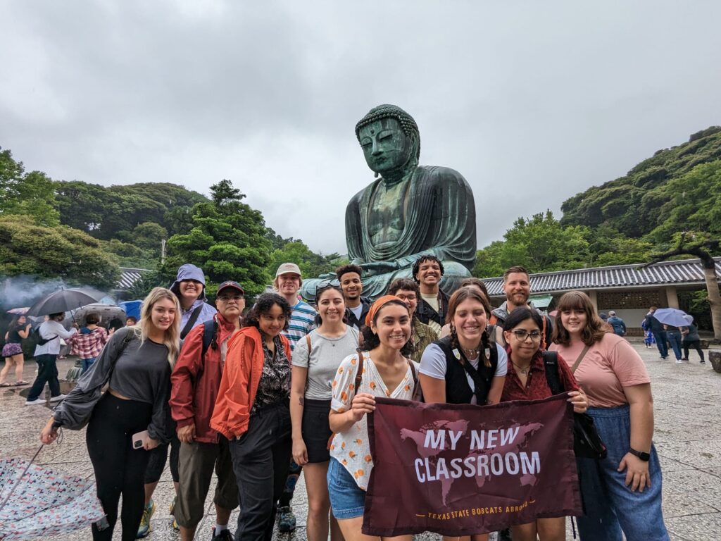 Texas State University students standing in front of the Great Buddha