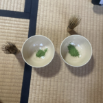 Tea cups of matcha and bamboo whisks to blend the matcha with water