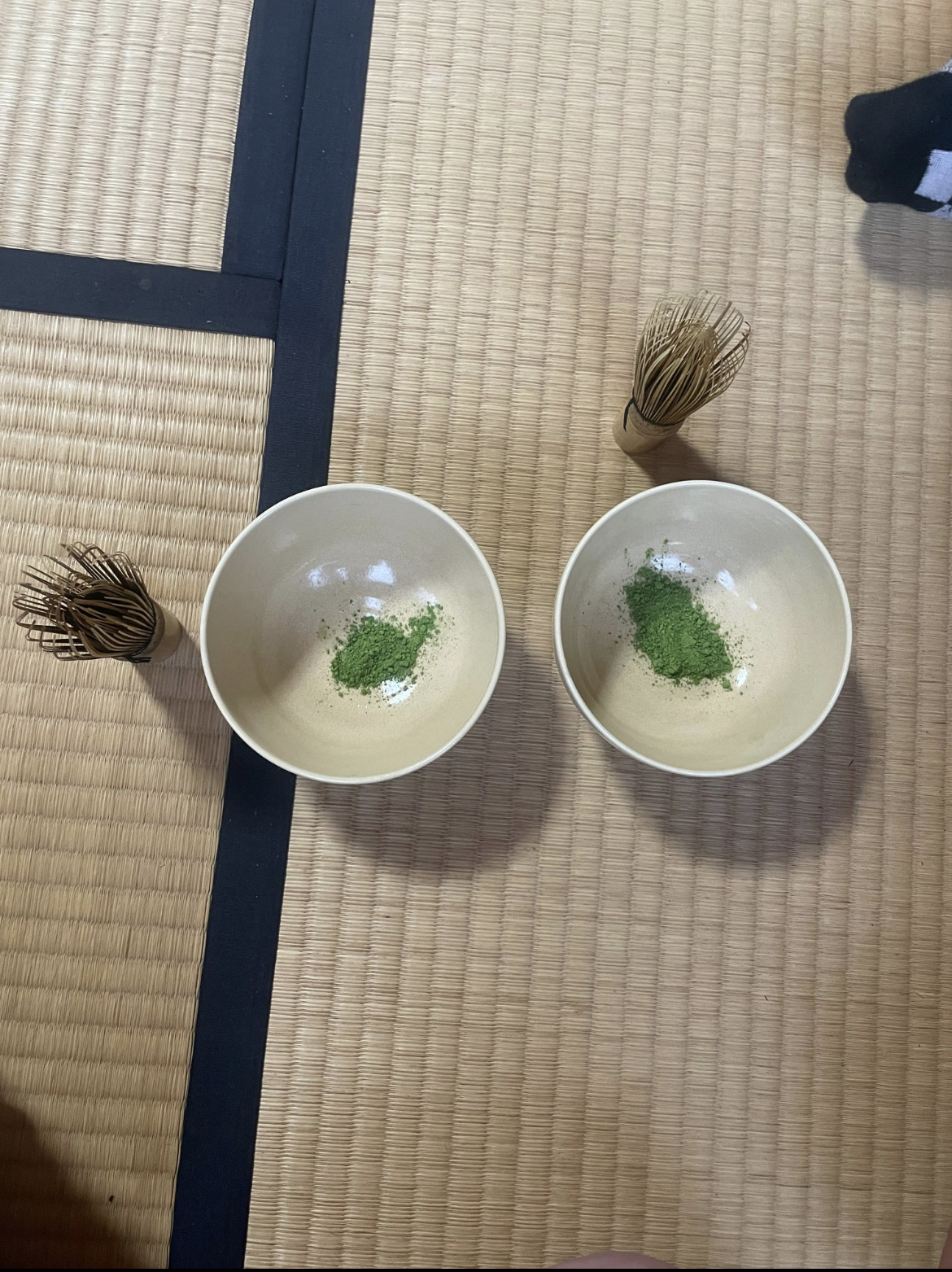 Tea cups of matcha and bamboo whisks to blend the matcha with water