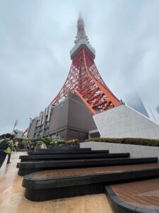 Photo of Tokyo Tower ascending into the clouds, highlighting the hight of the structure