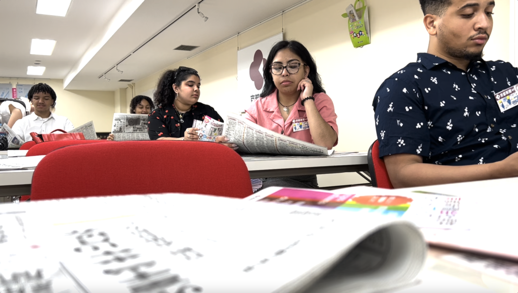 students look through copies of the Kyoto Shimbun