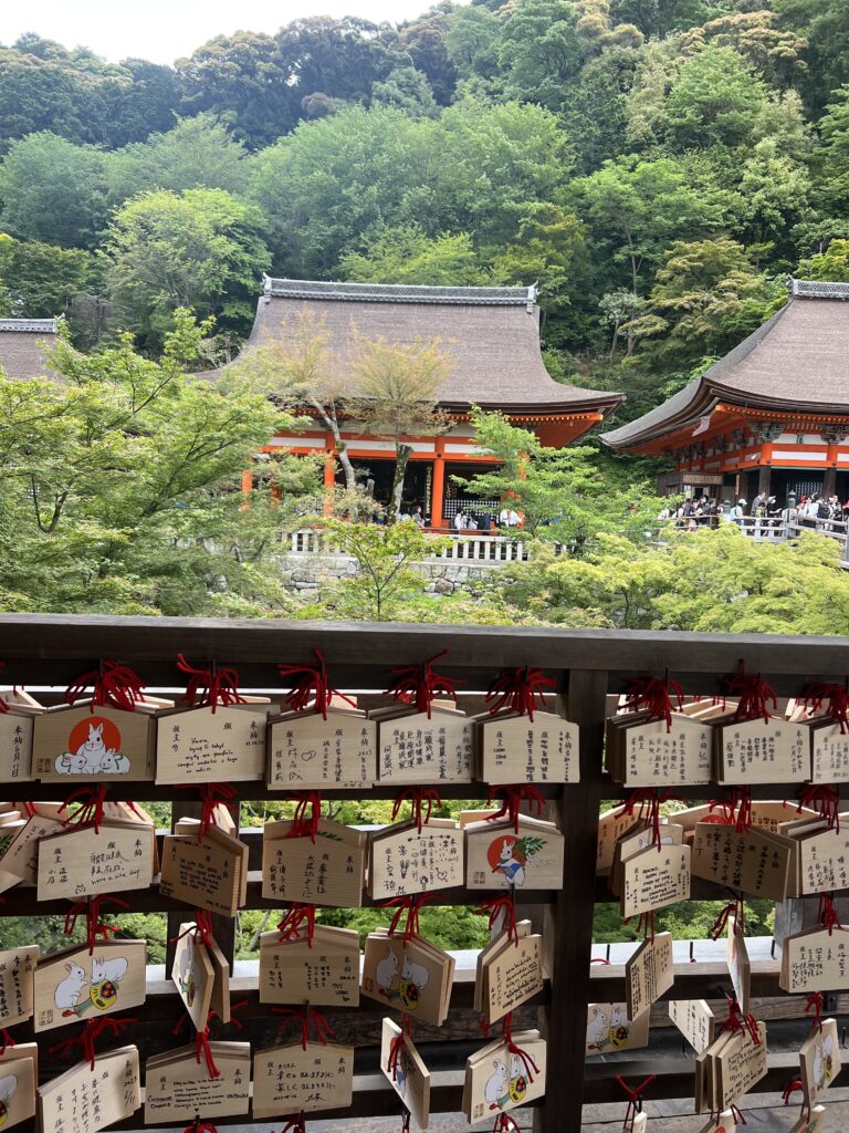 Ema (small wooden plaques for prayers) in front of a Kyoto pagoda